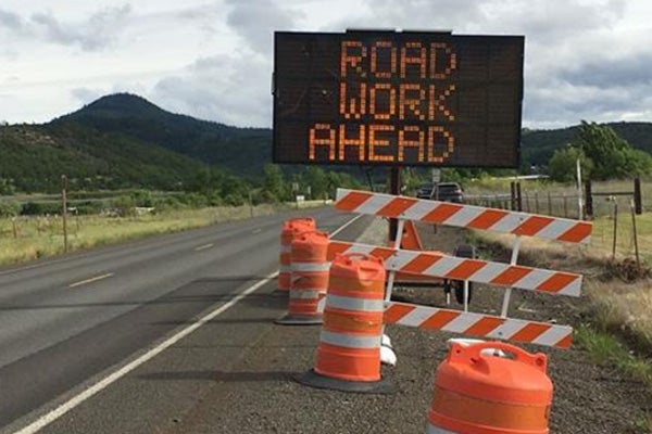 Road Work Ahead sign on the road