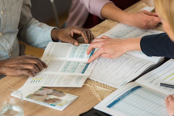 People looking through brochures at a table