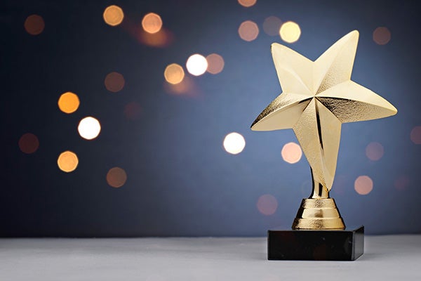 A star trophy against a celebratory background