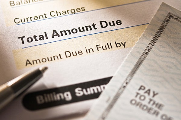 A portion of a bill covered by a blank check