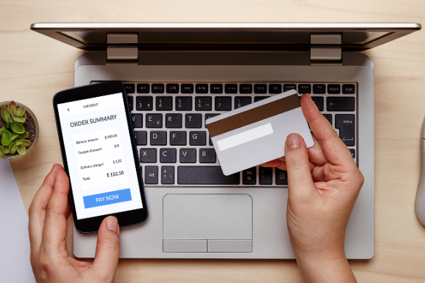online bill being paid by card via mobile or laptop